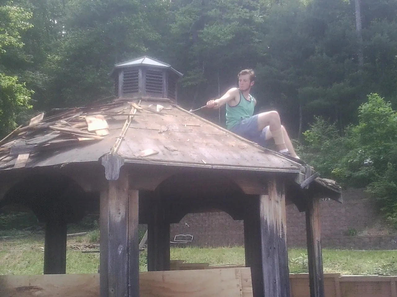 Tearing the old roof off a wooden gazebo before new shakes in Casa Grande